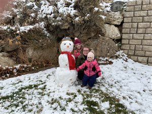 Kristi my daughter in law and my 2 granddaughters showing off their snowman:)
